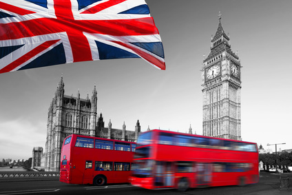 Big Ben with city buses and flag of England, London